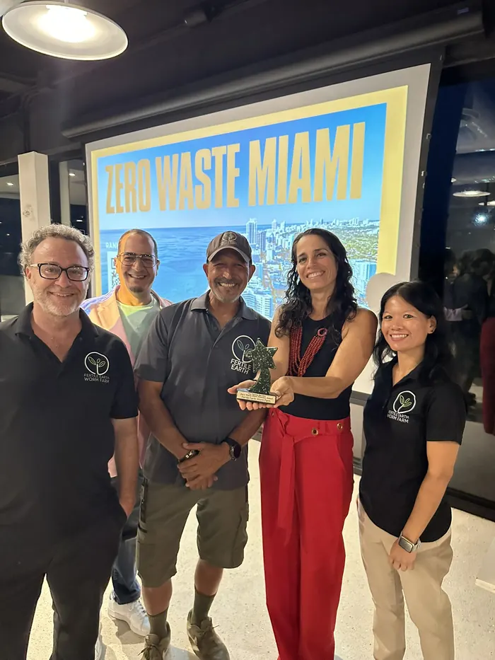 The Fertile Earth team accepting the Pamela Barrera Zero-Waste Business Award at the Zero Waste Miami event