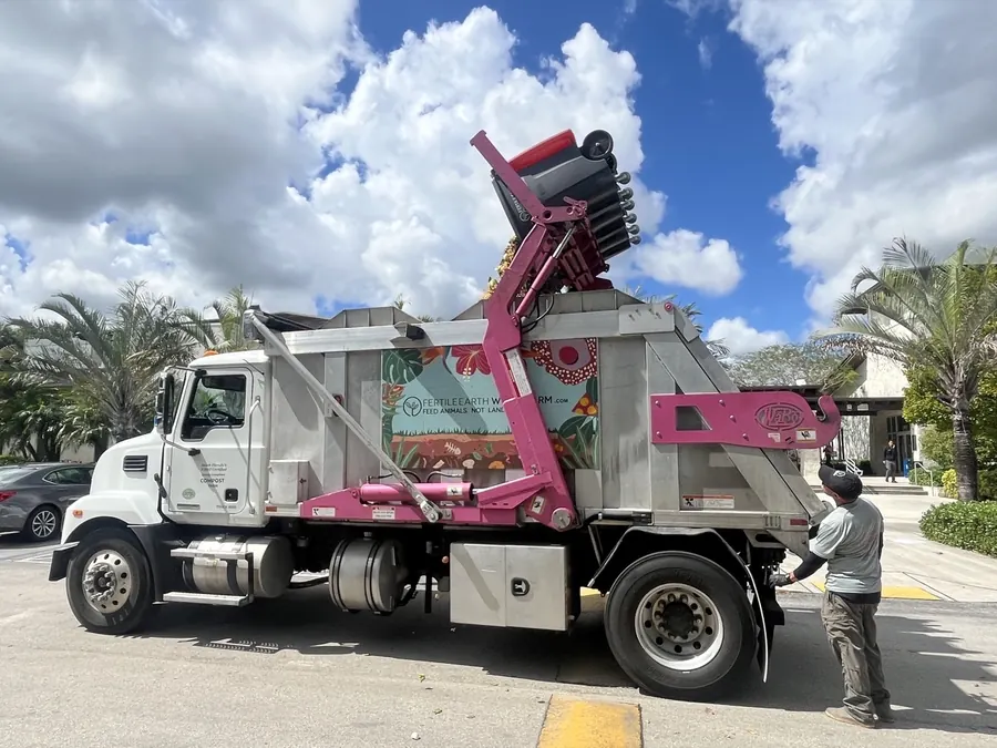 A Fertile Earth truck lifting and emptying a commercial food-scrap toter at a client site