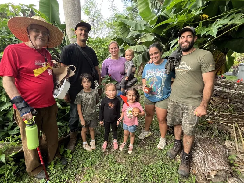 Agroforestry workshop participants and families together in the food forest at Fertile Earth