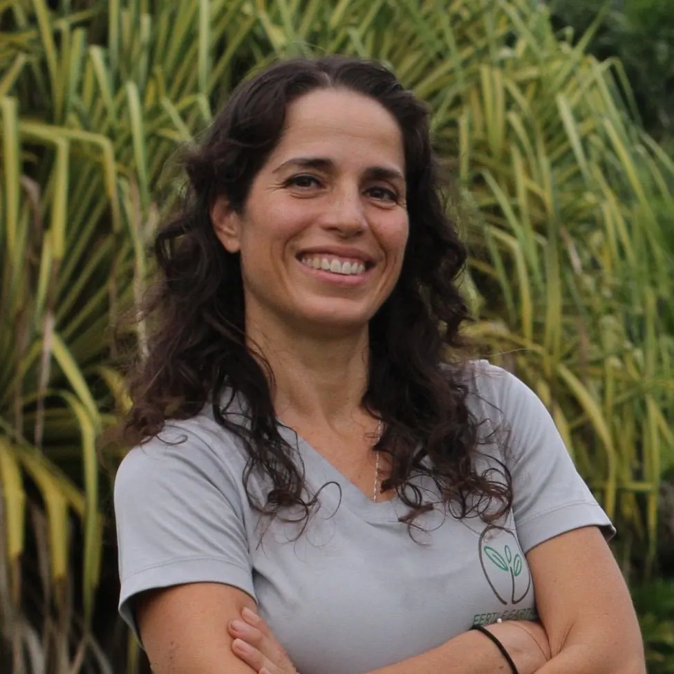 Dr. Lanette Sobel, founder and CEO of Fertile Earth, smiling in the farm’s tropical garden