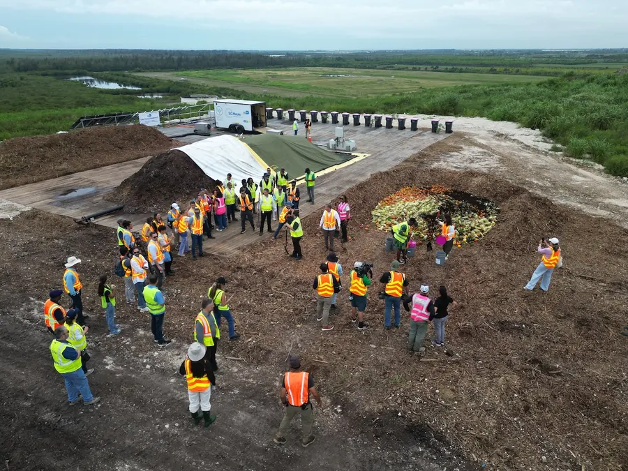 County officials and partners in safety vests touring the composting pilot site on top of the South Dade Landfill