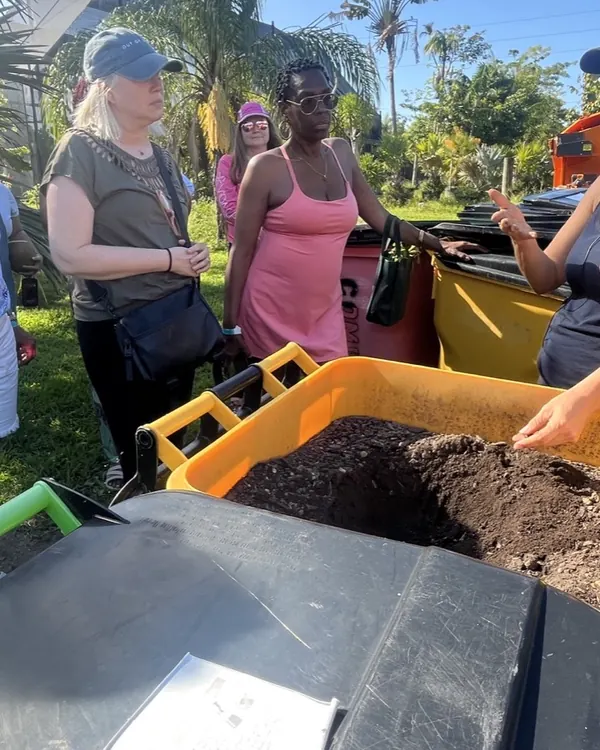 A volunteer showing a tub of finished compost