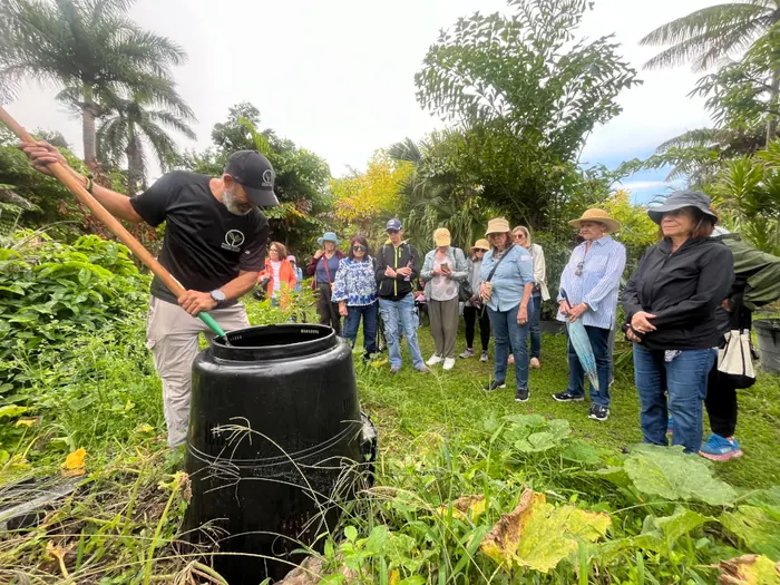 Participants at a hands-on composting workshop at the farm