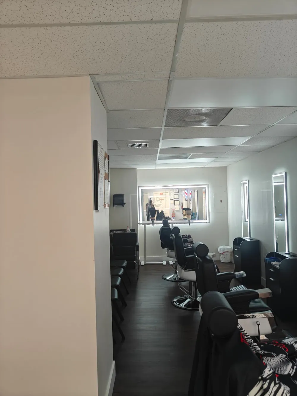 Row of barber chairs and stations in the barbering lab at Florida Professional Institute