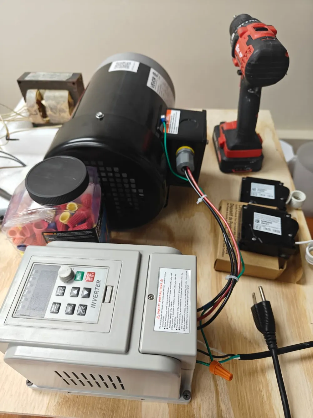 Electric motor, drive controller and test equipment on a lab workbench at Florida Professional Institute