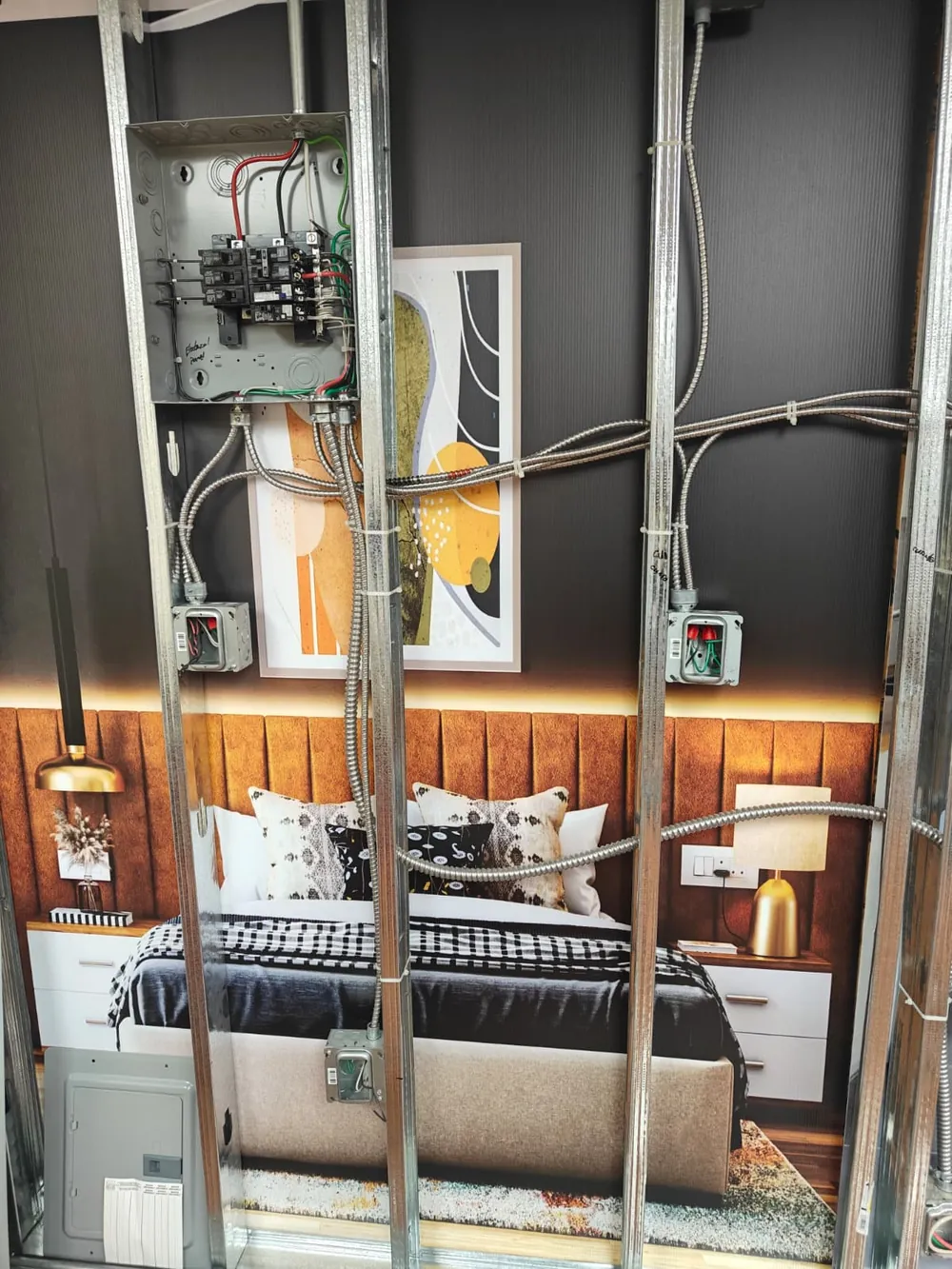 Steel stud practice wall with a breaker panel, conduit and outlet boxes in the electrical lab